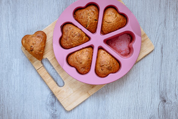 Homemade cupcakes in a baking mould on a wooden board