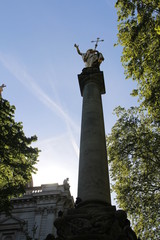 Fototapeta premium Gilt statue of Saint Paul at the top of St Paul's Cross in the cathedral precinct at St Paul's Cathedral, London, UK