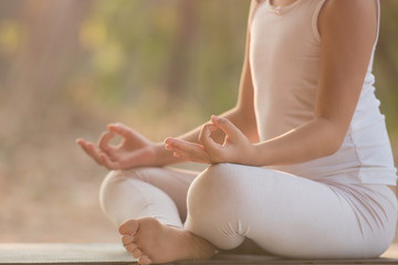 Fototapeta na wymiar calmness and relax, female happiness.Horizontal, blurred background. little asian girl meditates while practicing yoga. freedom concept. calmness and relax, woman happiness. toned picture healthy life