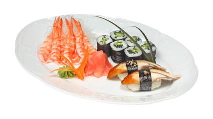 Sushi with eel and rolls with cucumber and nori. Shrimps, rice noodle, ginger and wasabi on white oval plate