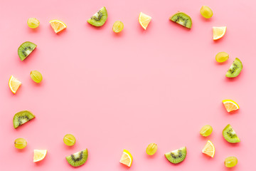 Colorful summer fruits frame on pink background top view copy space