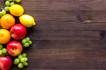 Colorful summer fruits frame on wooden background top view copy space