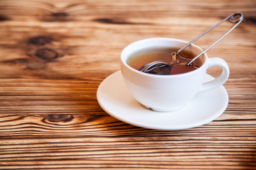 Cap of tea on the wooden table.