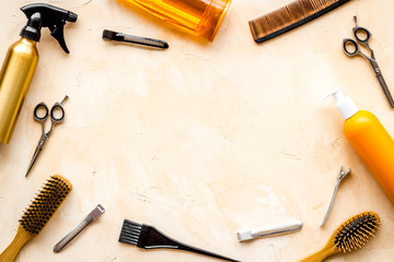 Hairdressing mockup - with brush, spray and sciccors - on beige background top-down frame copy space