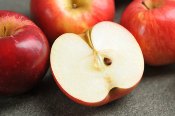 half of a red Apple. Apples on a gray