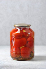 glass jar with iron lid with canned red tomatoes
