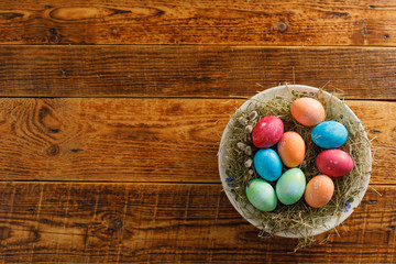 Still life of easter eggs in a bird's nest on a wooden background. Rustic. Decoration of natural. Easter celebration concept. Flat lay