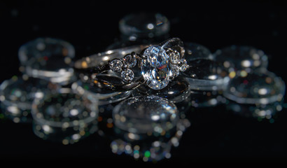 Silver engagement ring on black background