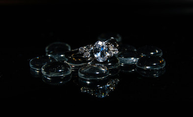 Silver engagement ring on black background