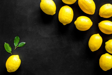 Lemons frame. Whole fruits on black backgroud top-down copy space
