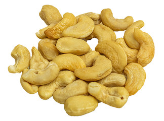 Cashew kernels in a glass plate on a wooden background