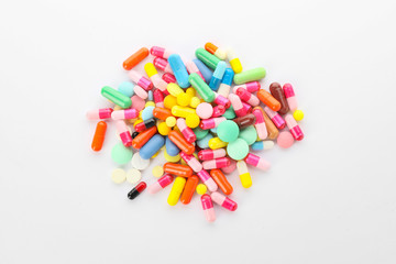 Heap of different pills on white background