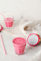 Glass of dragon fruit smoothie on white background