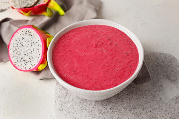 Bowl with dragon fruit smoothie on white background
