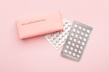 Contraceptive pills on color background