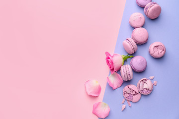 Tasty macarons on color background