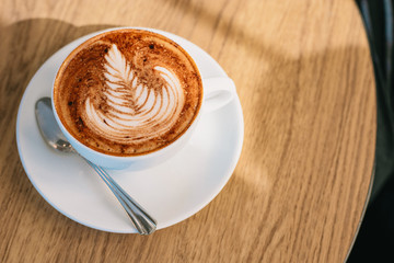 Coffee latte art on wooden table