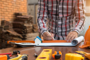 Engineer and Architect planing and discuss at Construction Site with blueprint