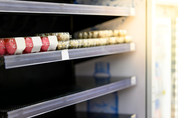 Empty egg shelves in a grocery store or supermarket. Hoarding food due to Coronavirus outbreak. Prepare food supplies for the worst case of COVID-19 pandemic. Stockpiling crisis all around the world. © zephyr_p