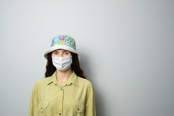 positive girl in medical mask and panama