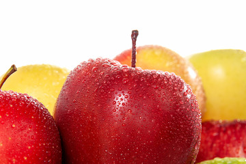 Ripe apple in water droplets close-up on a white background. Free space for text.