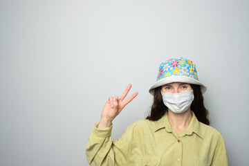 positive girl in medical mask and panama