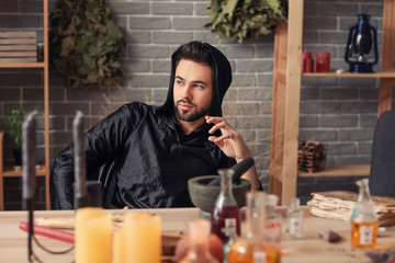 Male alchemist making elixir in laboratory