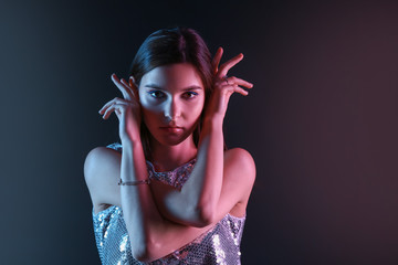 Toned portrait of beautiful young woman on dark background