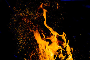 flame of fire with sparks on a black background