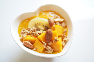 a bowl of mango smoothie