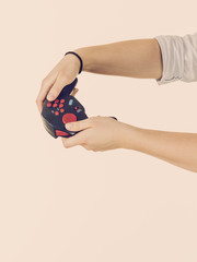 Woman hand holding gaming pad