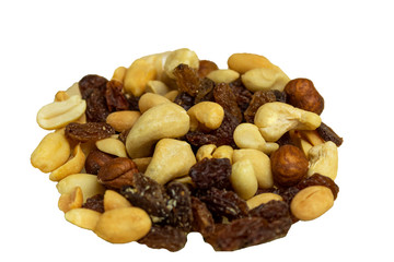 Raisins and nuts scattered on a wooden background