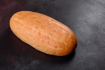 Fresh baked white bread on a brown concrete background