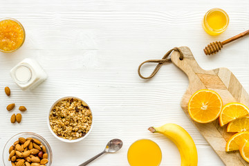 Vegetarian breakfast with granola and fruits on white background top-down frame copy space