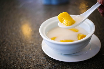 Thai Banana cooked in coconut milk in white bowl , Thai traditional Sweets dessert food.