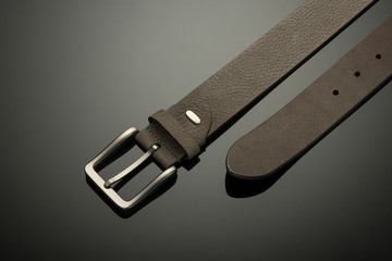 fashionable black leather men's belt on black background