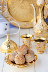 Fototapeta na wymiar Maamoul traditional arab filled pastry or cookie with dates or cashew or walnut or almond or pistachios nuts. Eastern sweets. Close up. White wooden background.