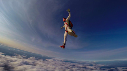 Fototapeta na wymiar Clean. Clear sky under your feet. A professional skydives. The flow of the wind.