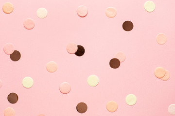 Pink,gold and yellow confetti on pink color paper background minimal style