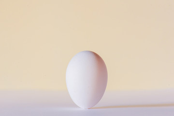 Close up of an egg laying on the table over white background