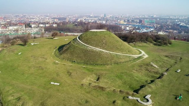 Krakus Mound in Krakow, Poland. Krakus was legendary founder of the town. The origin of the mound, probably early medieval kurgan, is not known. Old quarry in front. City panorama in the background