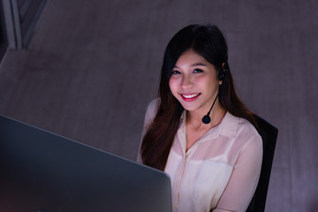 Asian call center business people working late night shift for helping assistance customer in...