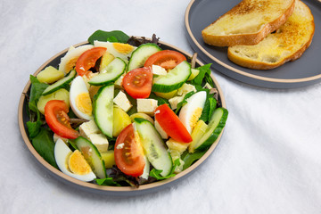 Egg, Feta, and some vegetable salad like cucumber, tomato and potato