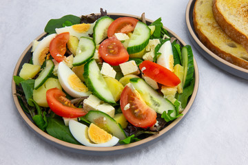 Egg, Feta, and some vegetable salad like cucumber, tomato and potato