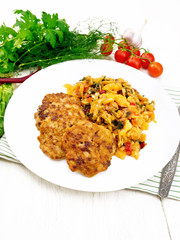 Fritters meat with cabbage in plate on towel