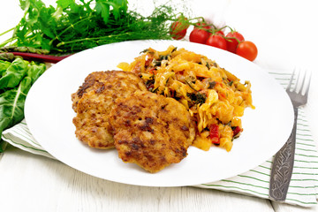 Fritters meat with cabbage in plate on wooden board