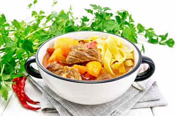 Lagman in bowl on light board