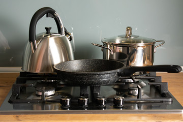 Modern gas stove in the house with various cookware