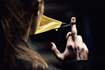 Obraz premium The reverse side of the virus protective mask is worn on the girl