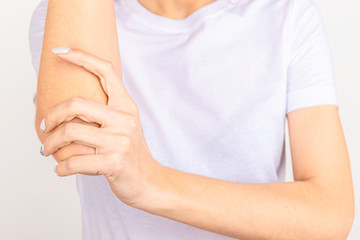Woman suffering from chronic joint rheumatism. Elbow pain and treatment concept